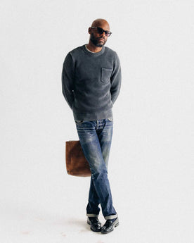 The Crawford Crew Sweater in Washed Asphalt on the hull of a boat, Knits by Taylor Stitch