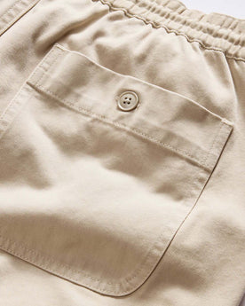 material shot of the back of The Apres Short in Organic Aged Stone Foundation Twill, Bottoms by Taylor Stitch