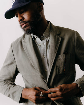 fit model putting something in the pocket of The Foundation Sportcoat in Organic Smoked Olive Twill, Outerwear by Taylor Stitch