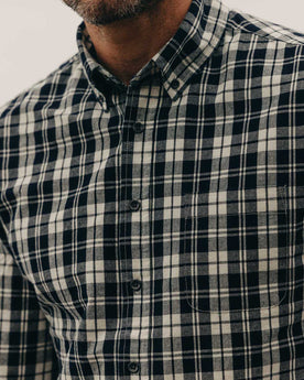 fit model showing off the buttons on The Jack in Rinsed Indigo Plaid, Wovens by Taylor Stitch