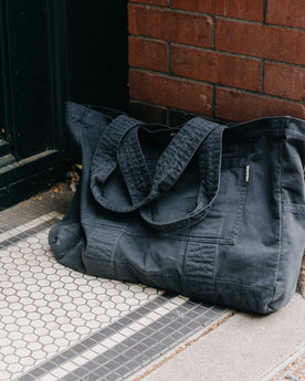 editorial image of The Foundation Tote in Organic Navy leaning against the wall, Accessories by Taylor Stitch