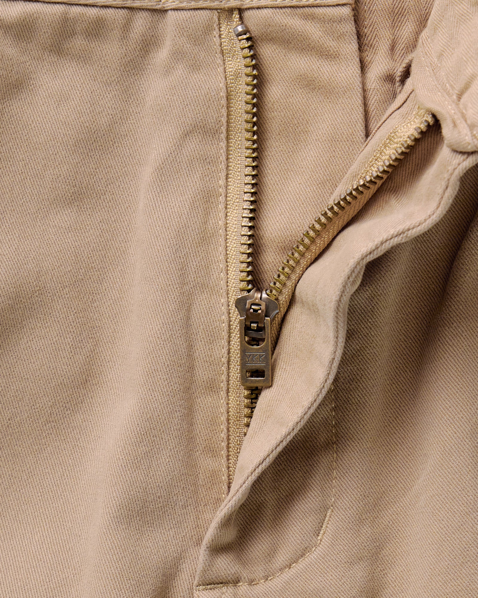 material shot of the zipper on The Democratic Foundation Pant in Organic Khaki, Bottoms by Taylor Stitch