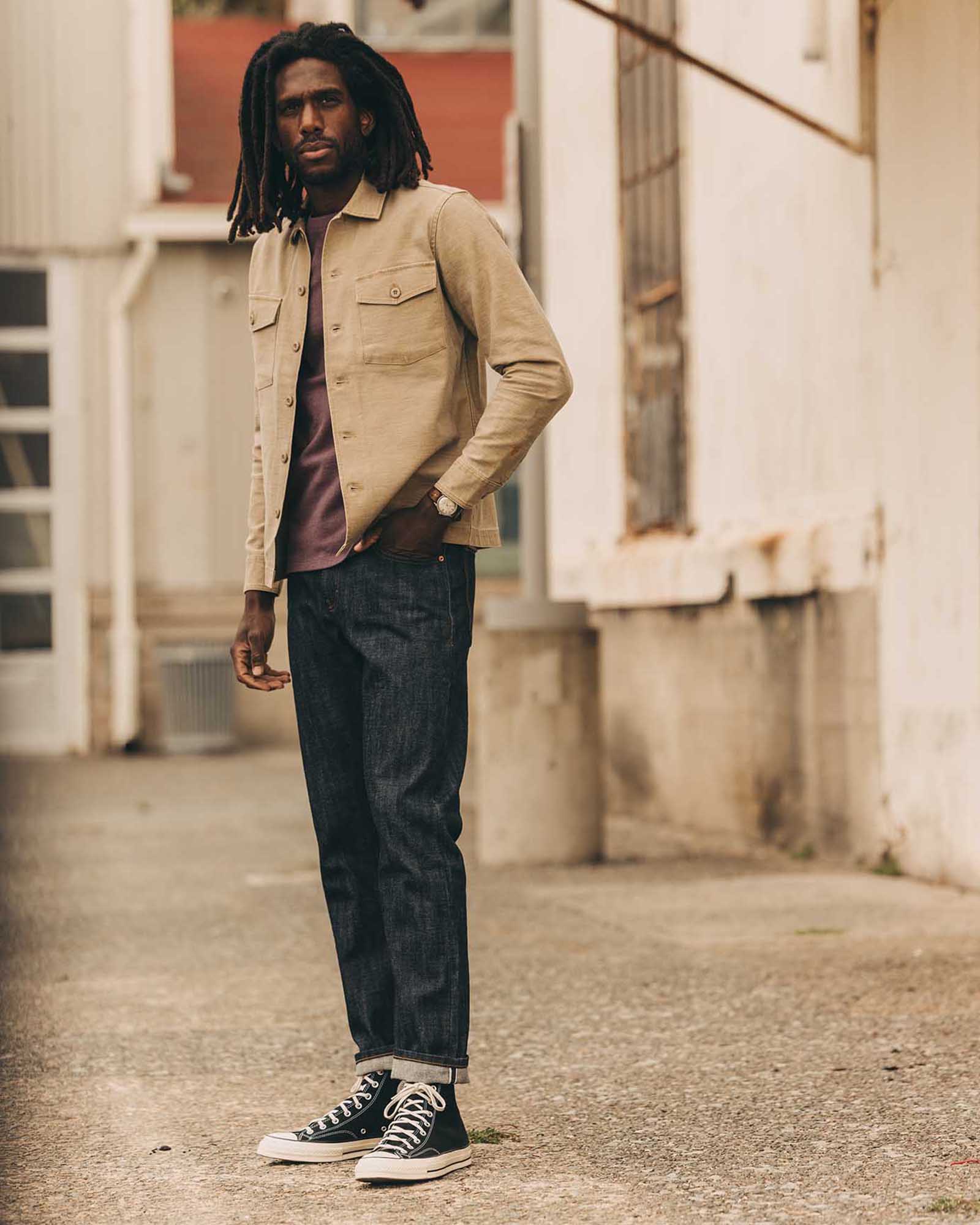 fit model posing in The Democratic Jean in Rigid Organic Selvedge, Bottoms by Taylor Stitch