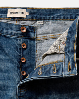 folded flatlay of the back of The Democratic Jean in Mid Wash Organic Selvedge, Bottoms by Taylor Stitch