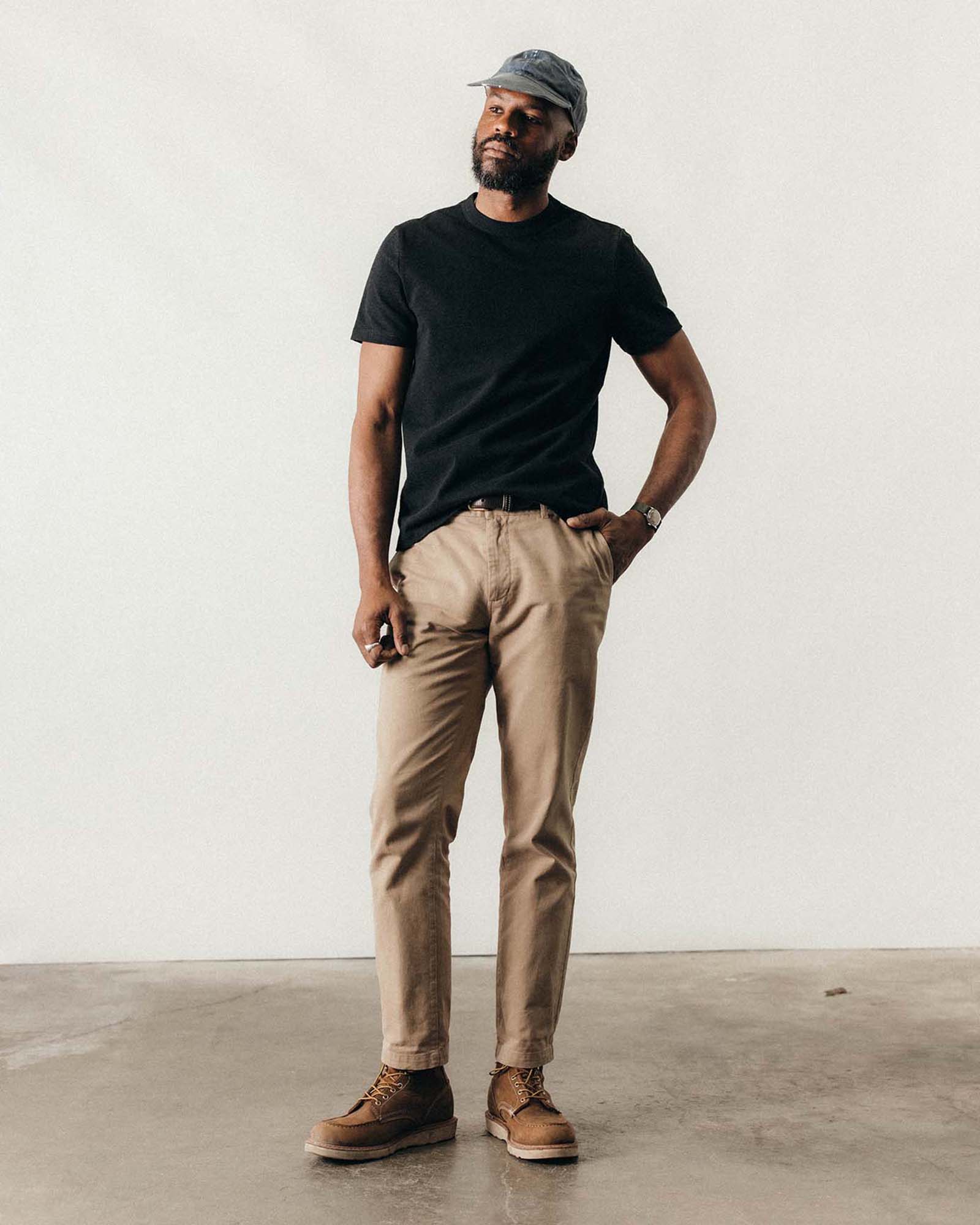 fit model with his hand in his pocket wearing The Organic Cotton Shop Tee in Coal Twist, Knits by Taylor Stitch