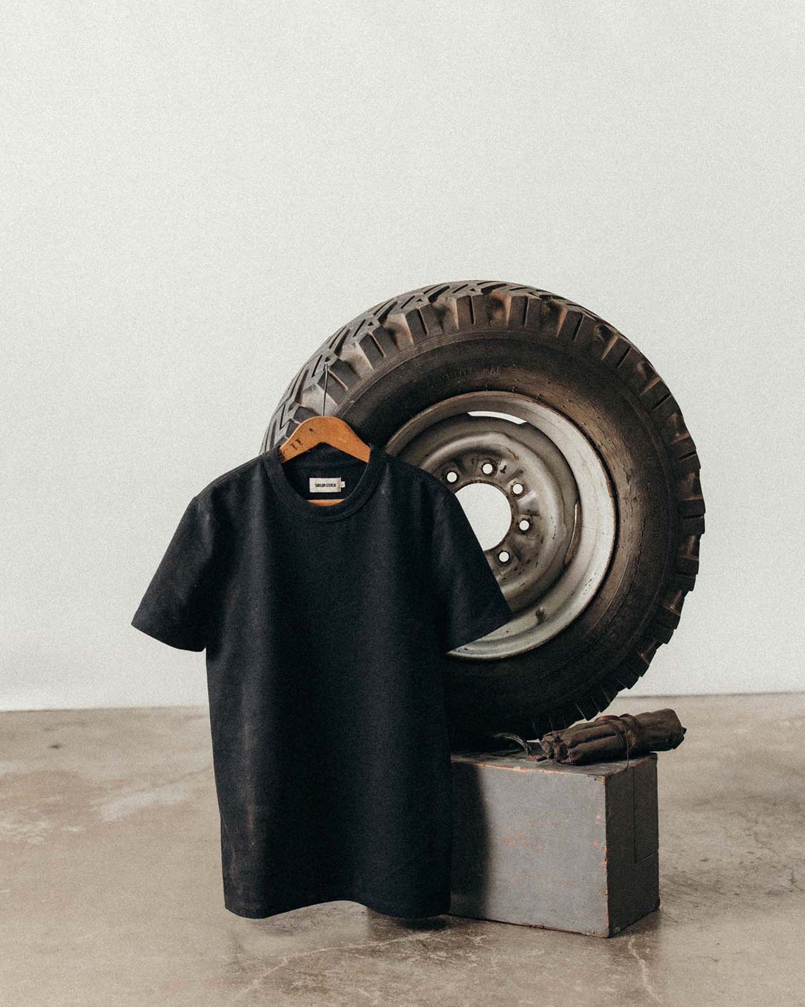 editorial image of The Organic Cotton Shop Tee in Coal Twist hanging, Knits by Taylor Stitch