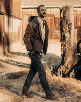 fit model walking wearing The Workhorse Hoodie in Aged Penny Chipped Canvas, Outerwear by Taylor Stitch