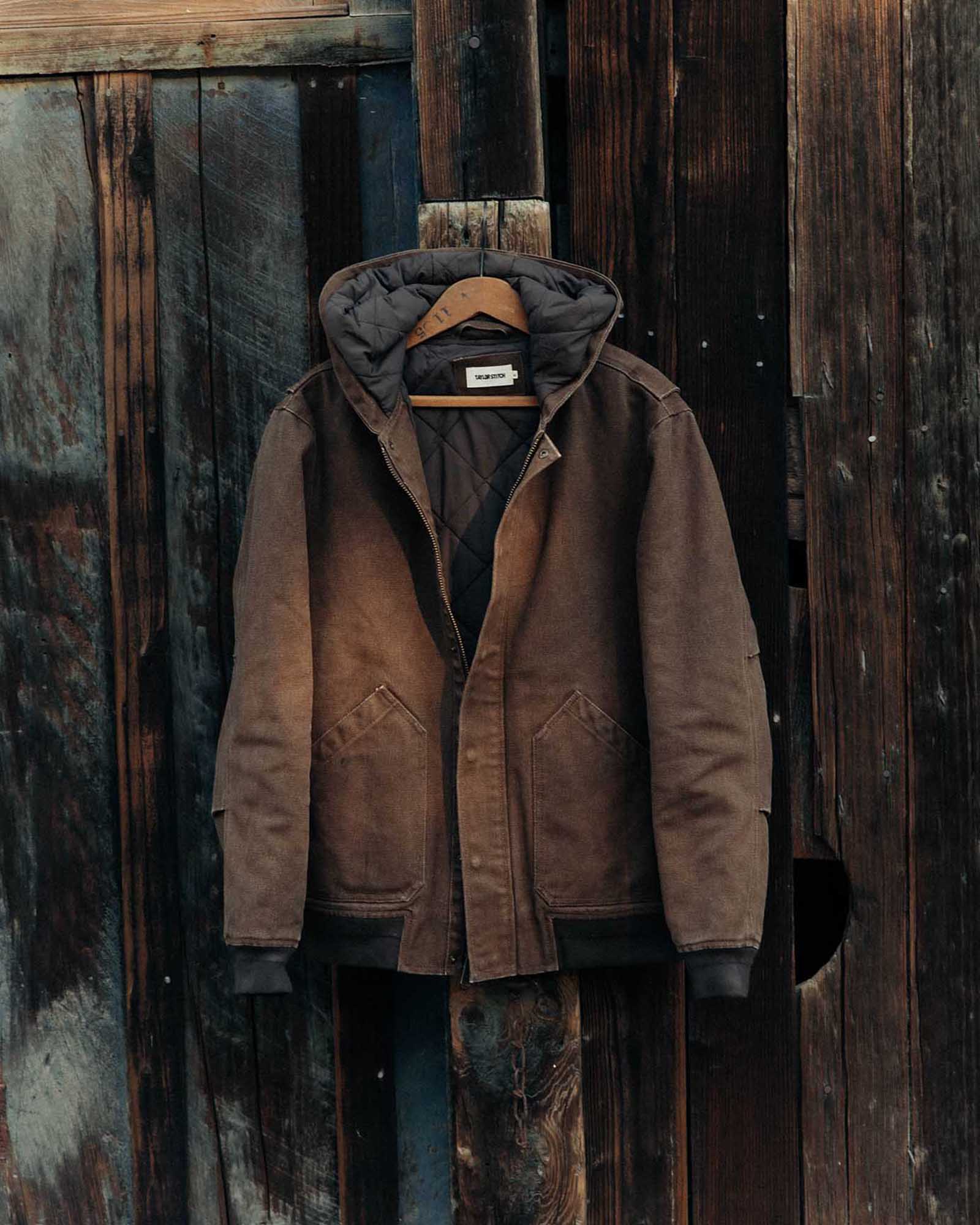 editorial image of The Workhorse Hoodie in Aged Penny Chipped Canvas hanging, Outerwear by Taylor Stitch