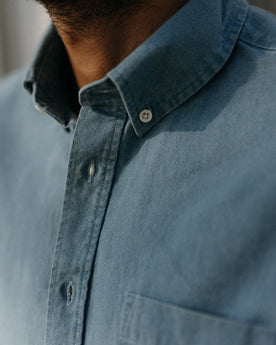 fit model showing off the buttons on The Jack in Washed Indigo Oxford, Wovens by Taylor Stitch