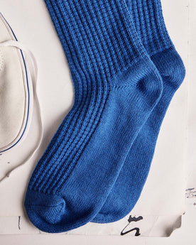 editorial flatlay of The Waffle Sock in Cobalt next to a shoe, Accessories by Taylor Stitch