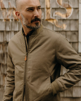 fit model wearing The Insulated Bomber Jacket in Fatigue Olive Dry Wax, Outerwear by Taylor Stitch