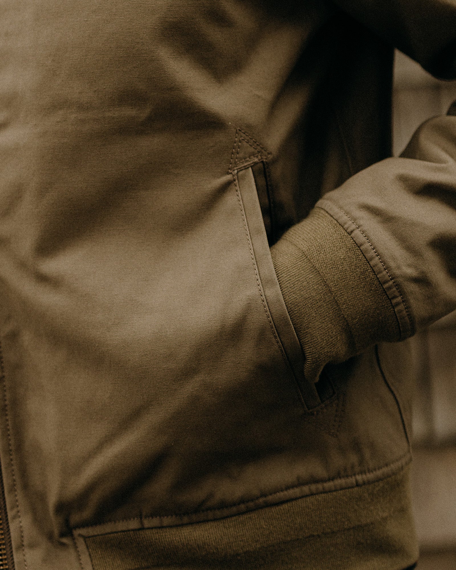 fit model walking in The Insulated Bomber Jacket in Fatigue Olive Dry Wax, Outerwear by Taylor Stitch