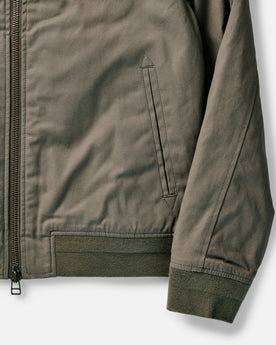 flatlay of The Insulated Bomber Jacket in Fatigue Olive Dry Wax, shown open, Outerwear by Taylor Stitch