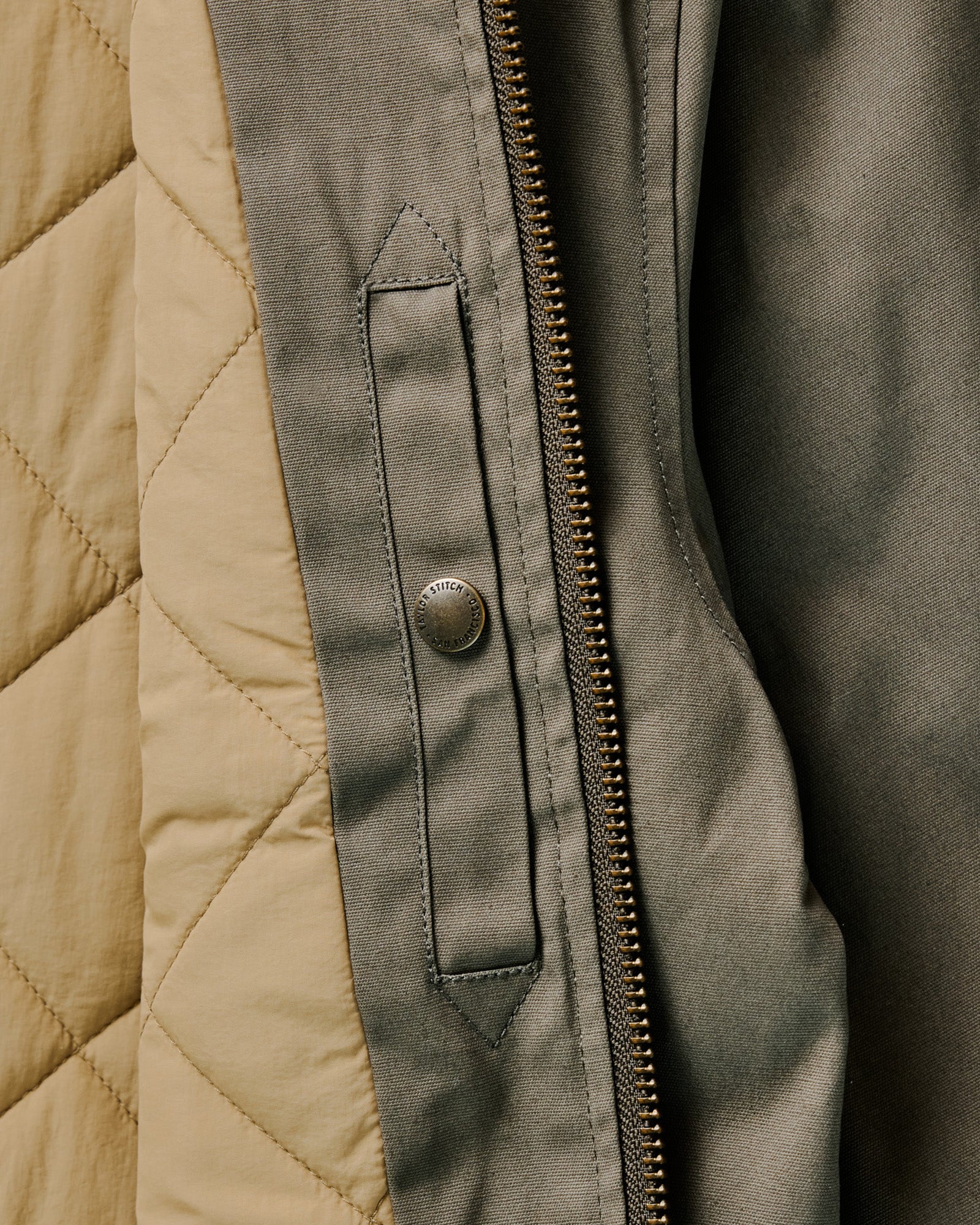 flatlay of The Insulated Bomber Jacket in Fatigue Olive Dry Wax, shown from the back, Outerwear by Taylor Stitch