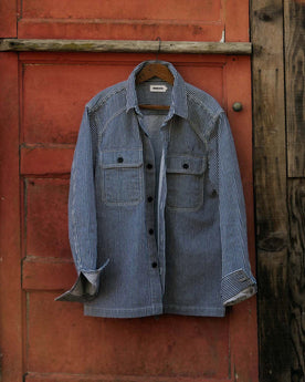 editorial image of The Shop Shirt in Rinsed Indigo Selvedge hanging, Wovens by Taylor Stitch