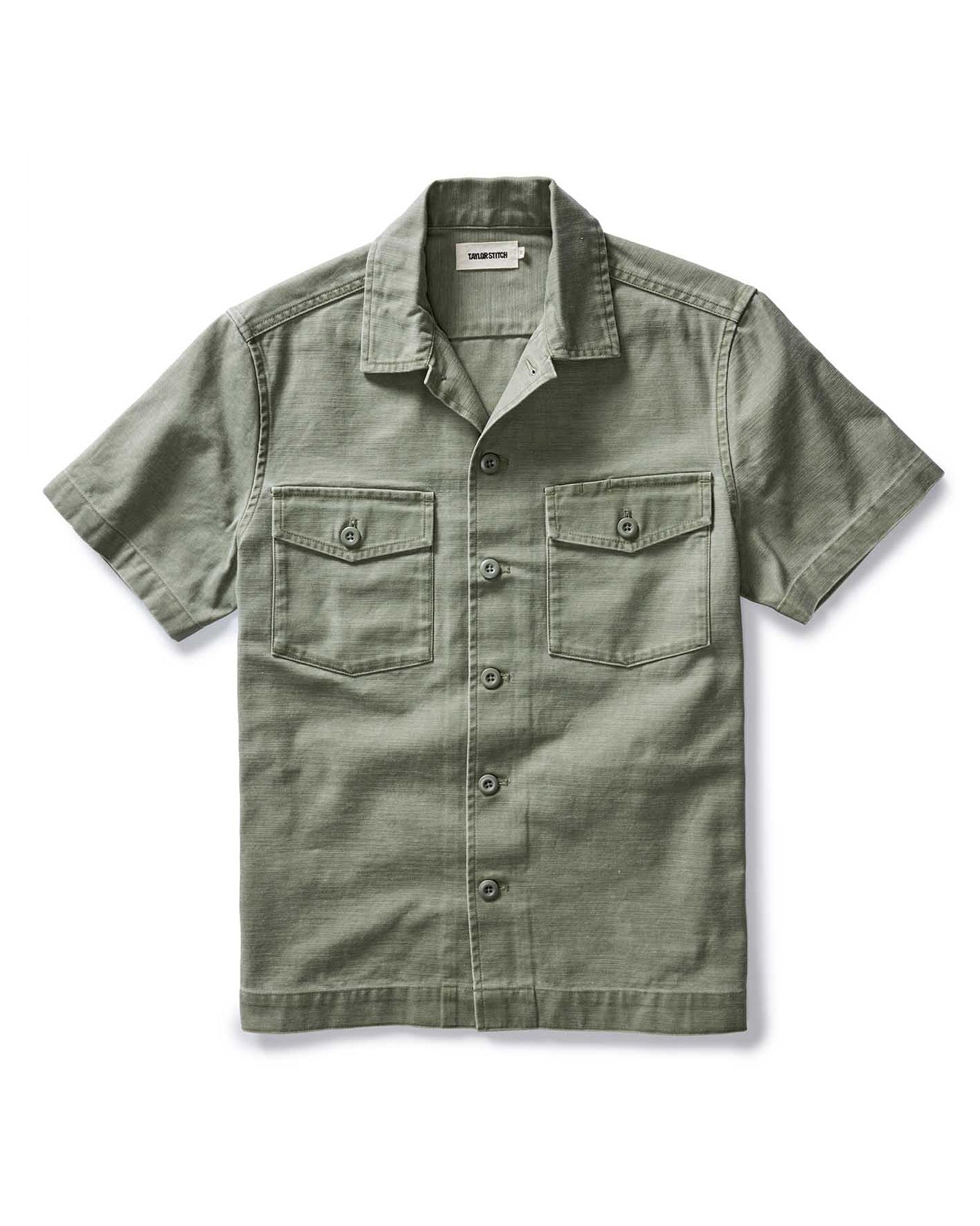 flatlay of The Short Sleeve Surplus Shirt in Field Olive Reverse Sateen, Wovens by Taylor Stitch