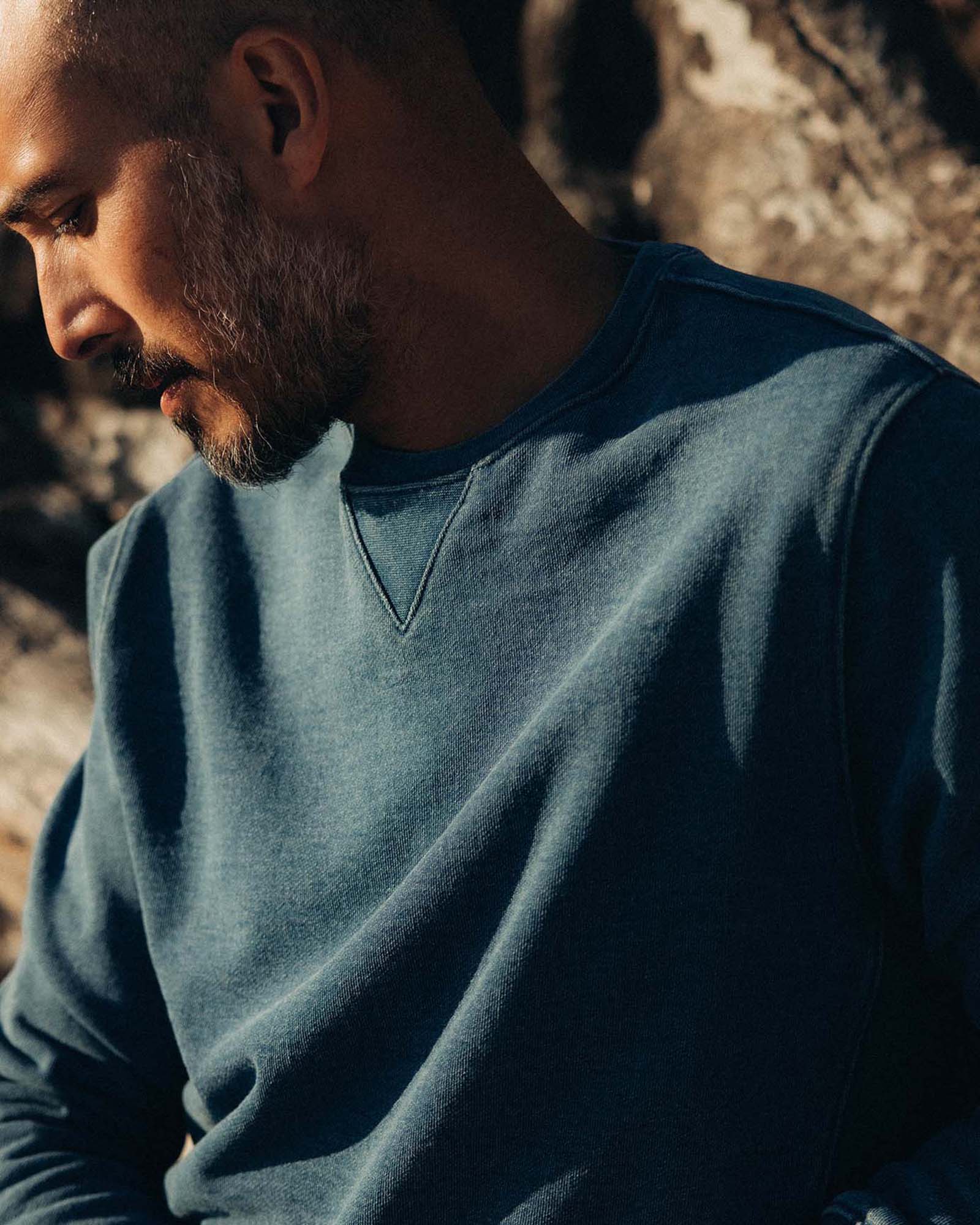 fit model leaning against a tree wearing The Apres Crew in Washed Indigo Terry, Knits by Taylor Stitch