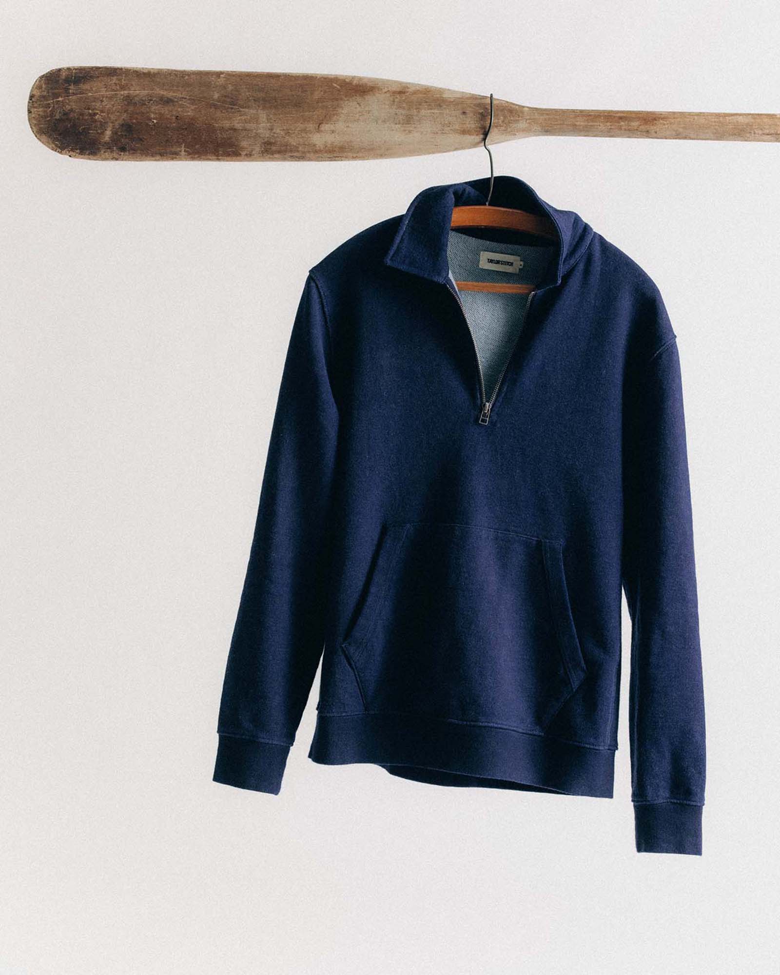 editorial image of The Apres Quarter Zip in Rinsed Indigo Terry hanging, Knits by Taylor Stitch