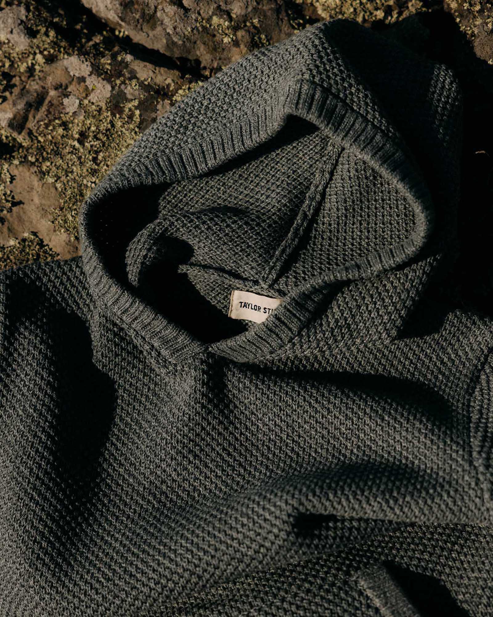 editorial flatlay of the hood on The Crawford Sweater Hoodie in Deep Sea Twist, Knits by Taylor Stitch