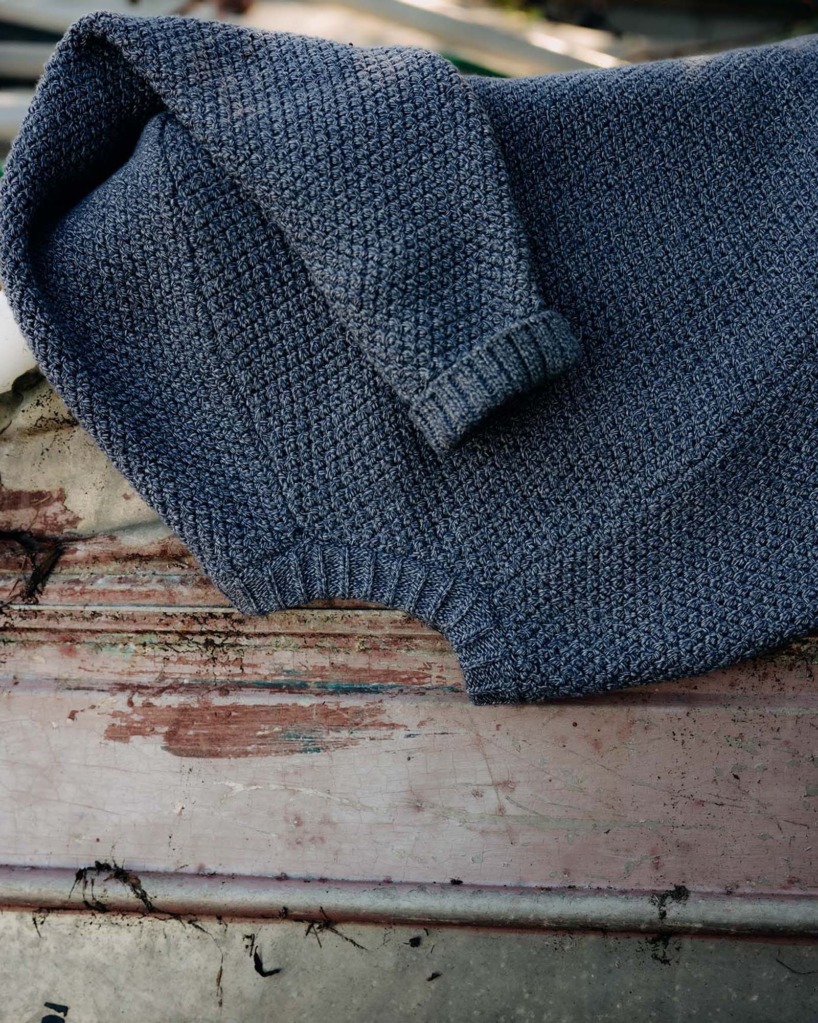 editorial image of The Fisherman Sweater in Blue Melange on a chair, Knits by Taylor Stitch