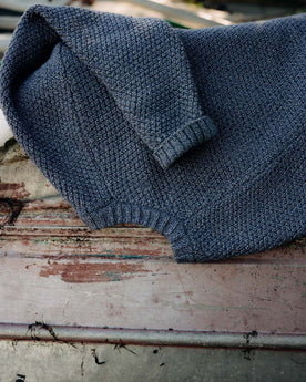 editorial image of The Fisherman Sweater in Blue Melange on a chair, Knits by Taylor Stitch