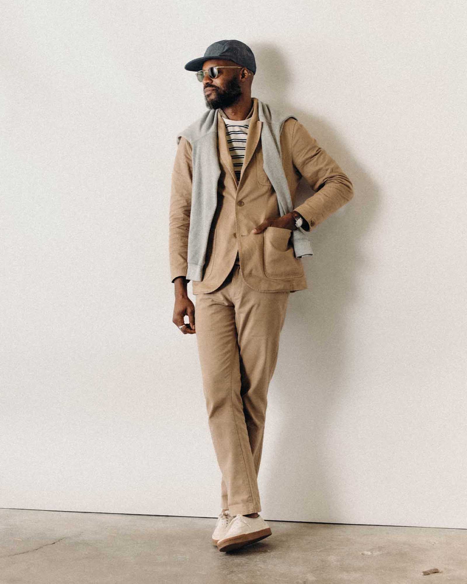 fit model leaning against the wall wearing The Foundation Sportcoat in Organic Khaki Twill, Outerwear by Taylor Stitch