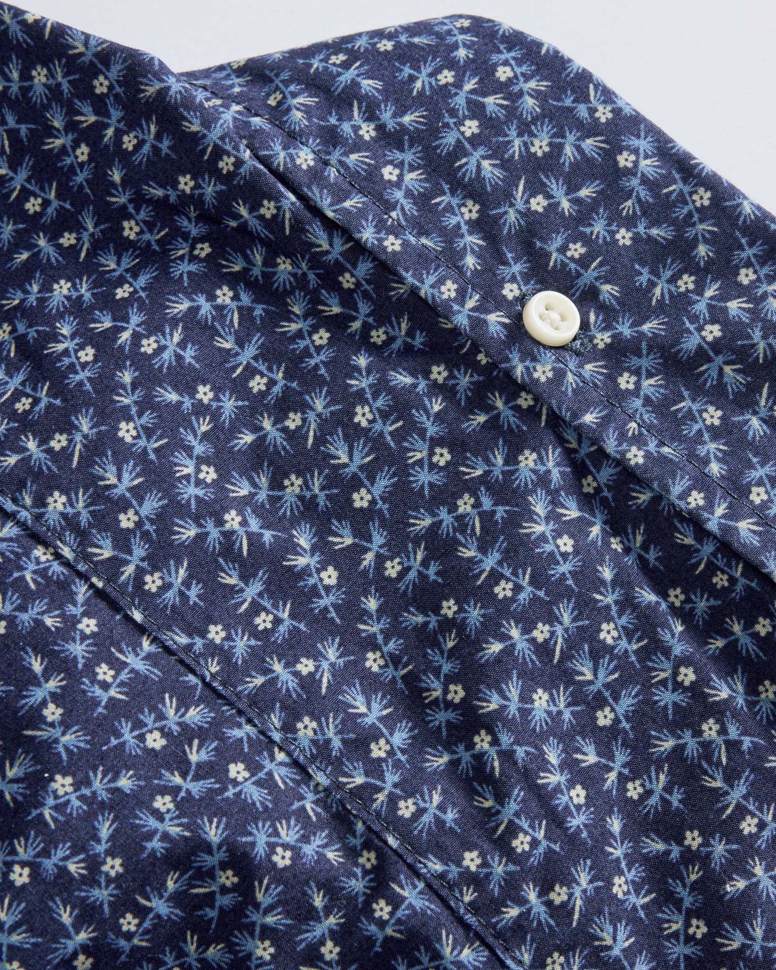 material shot of the button on the back of the collar for The Short Sleeve Jack in Falling Floral, Wovens by Taylor Stitch