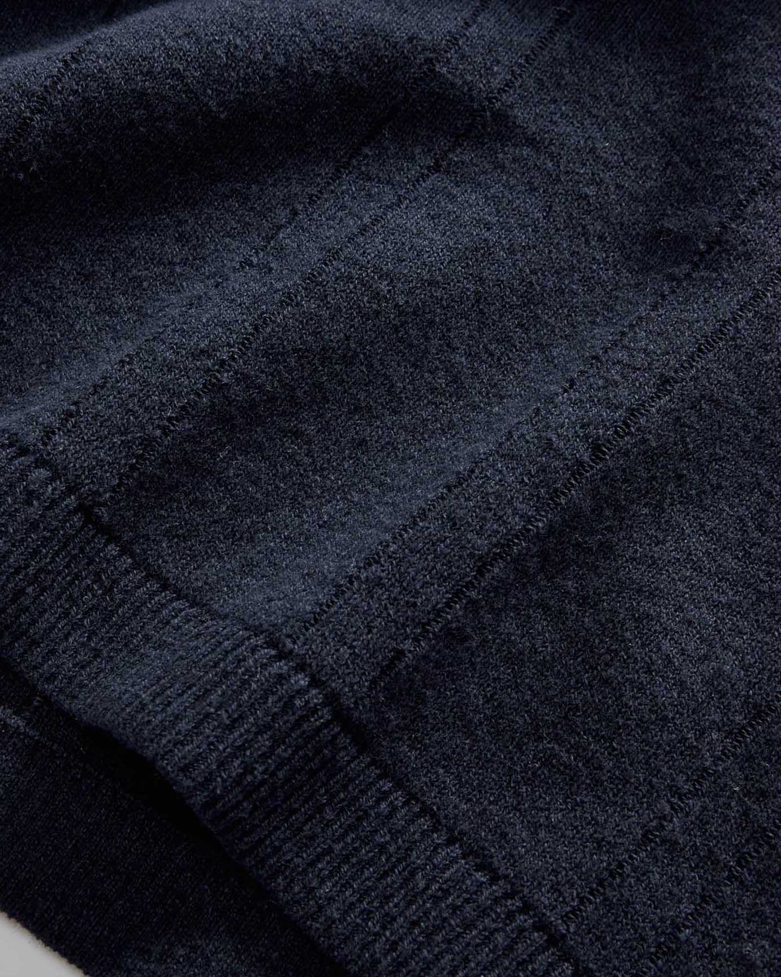 material shot of the hem on The Valencia Sweater Polo in Dark Navy Rib, Knits by Taylor Stitch