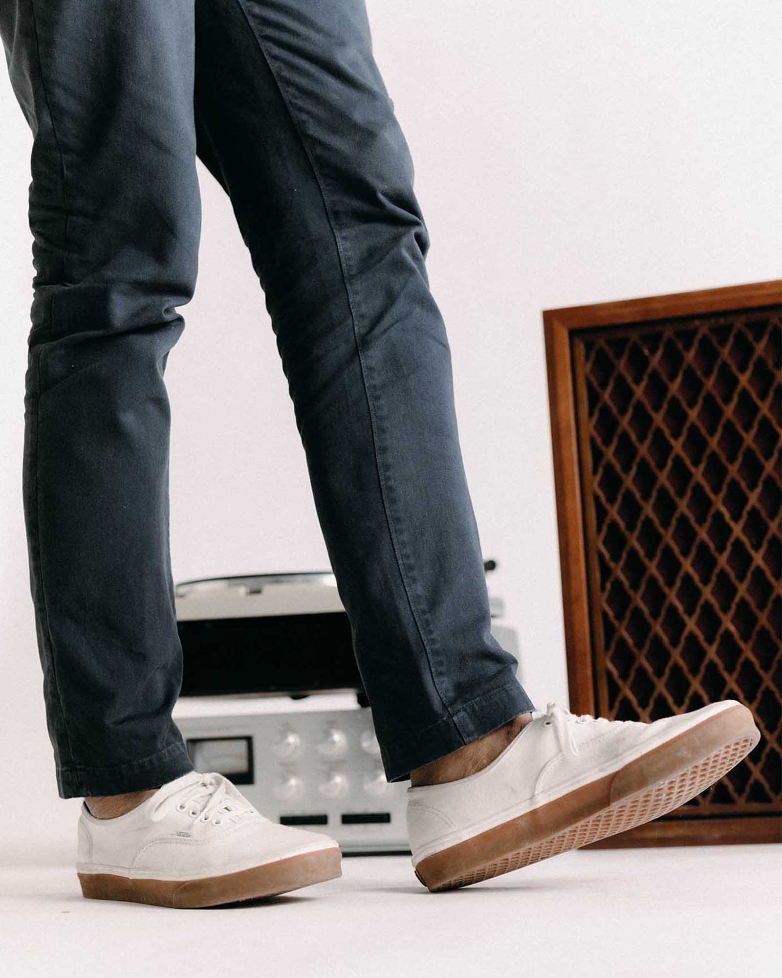 fit model walking wearing The Slim Foundation Pant in Organic Navy, Bottoms by Taylor Stitch