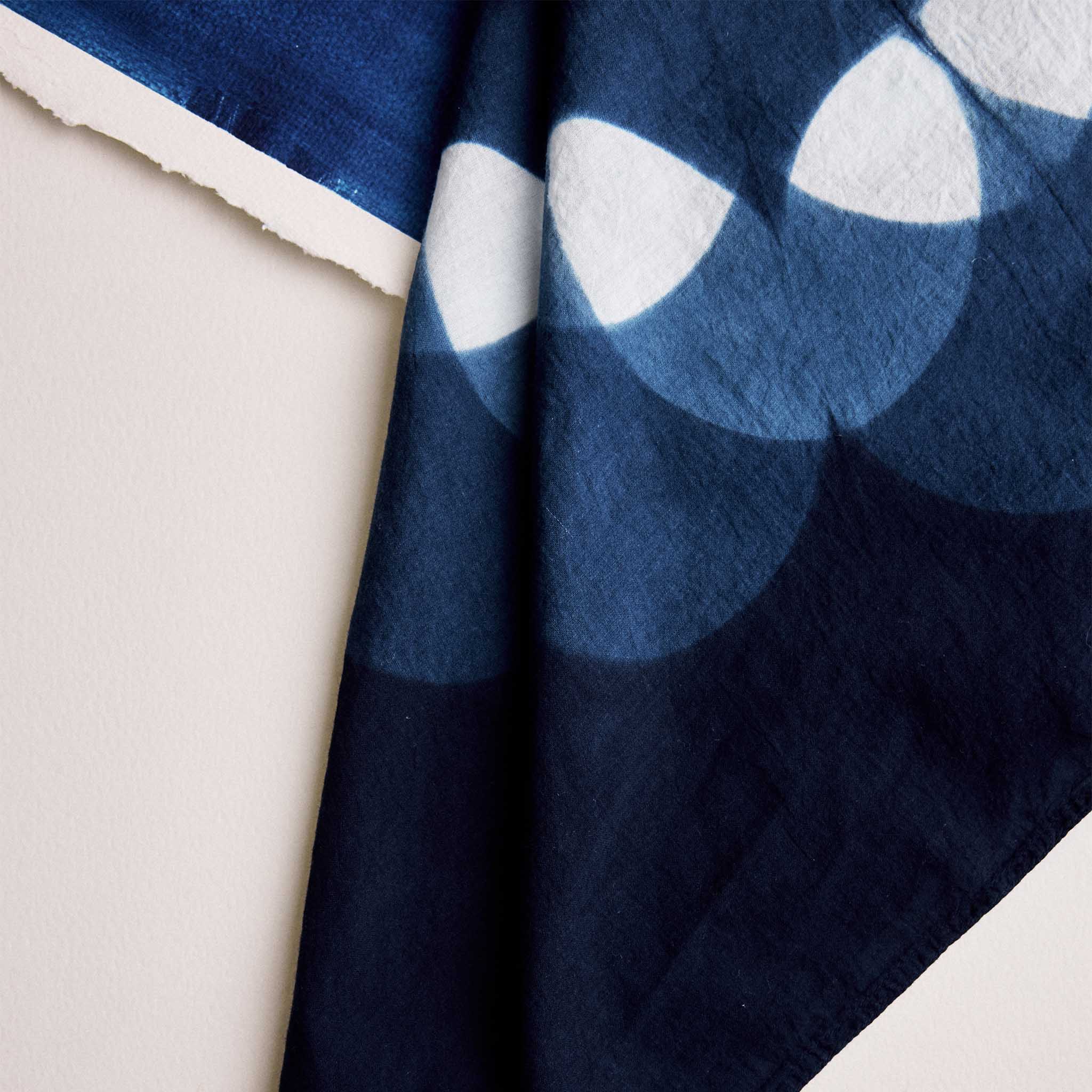 editorial faltlay of The Hand Dyed Bandana in Indigo Petal next to painting, Accessories by Taylor Stitch