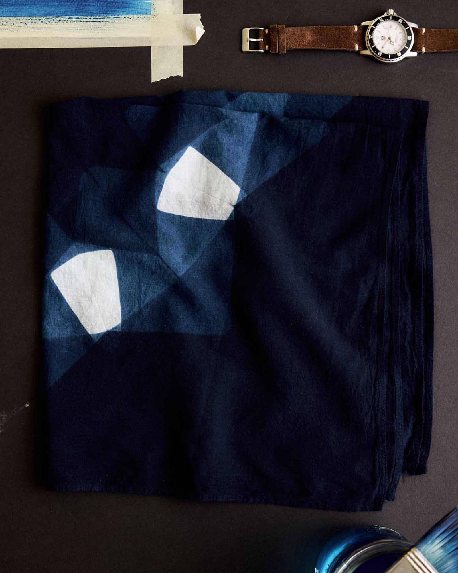 editorial image of The Hand Dyed Bandana in Indigo Burst folded, Accessories by Taylor Stitch