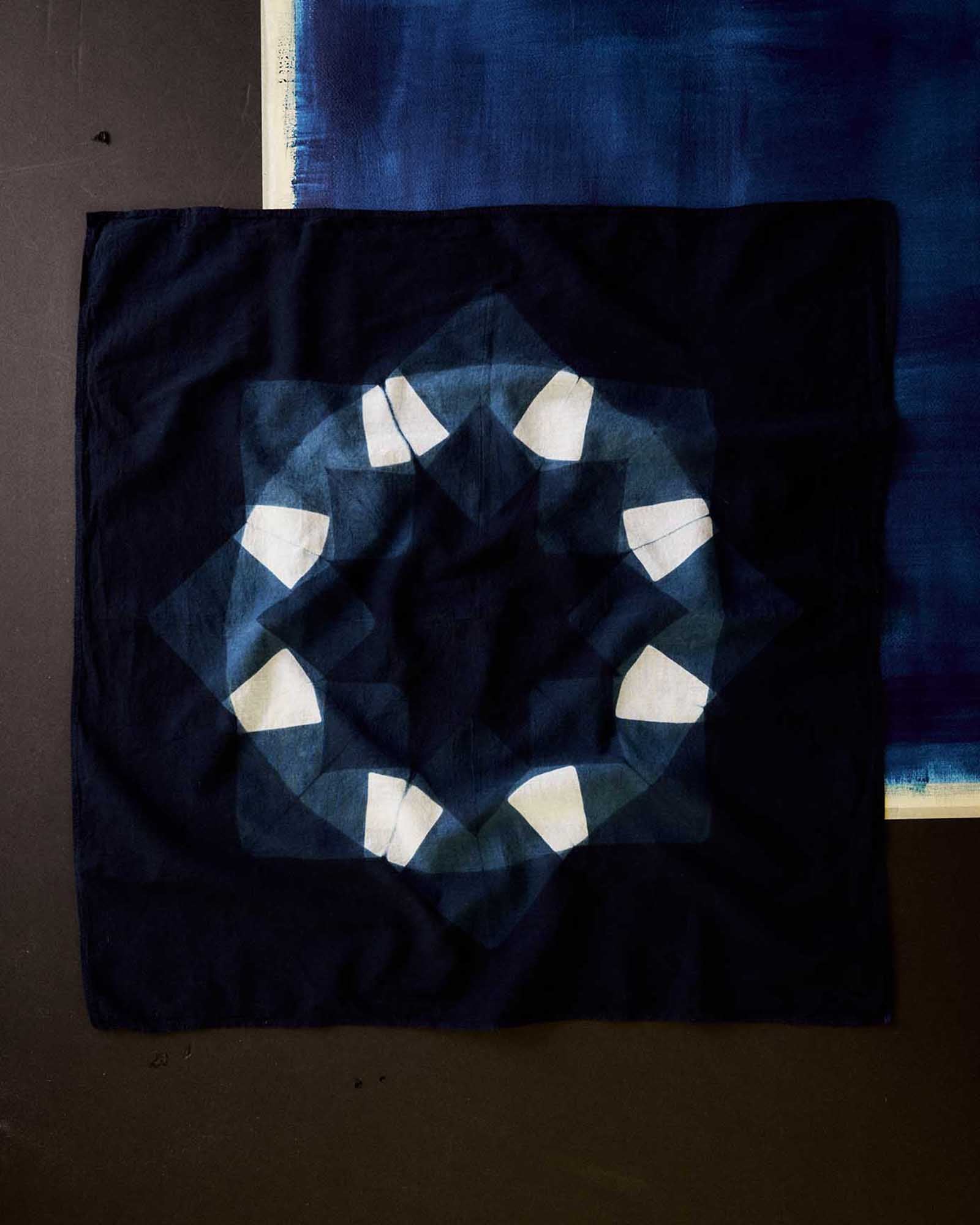 editorial flatlay of The Hand Dyed Bandana in Indigo Burst, Accessories by Taylor Stitch