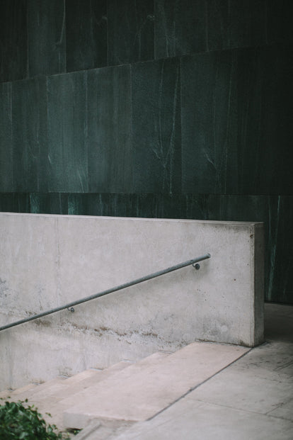 Architectural shot of concrete steps and handrail.