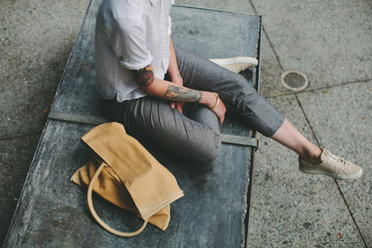 Sitting on a bench, modelling the pants - close up.