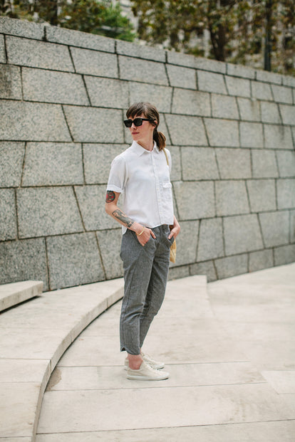 Modelling the pants - against a stone wall backdrop.