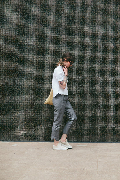 Modelling the pants - walking pas a mosaic wall.