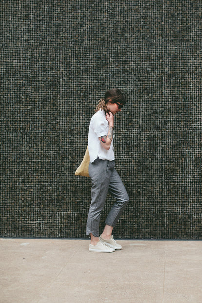 Modelling the pants - walking pas a mosaic wall.