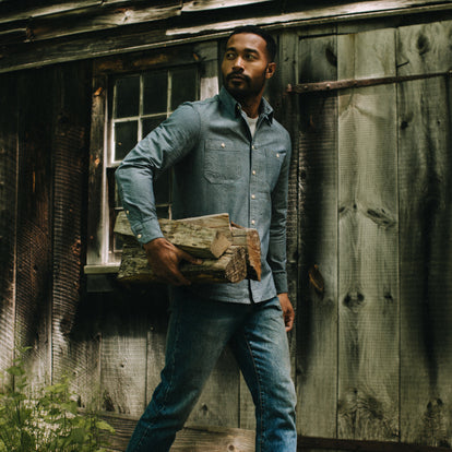 Model carrying logs in The Utility Shirt