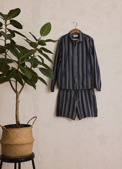 The Clark Jacket and The Après Short in Indigo Stripe on a hanger