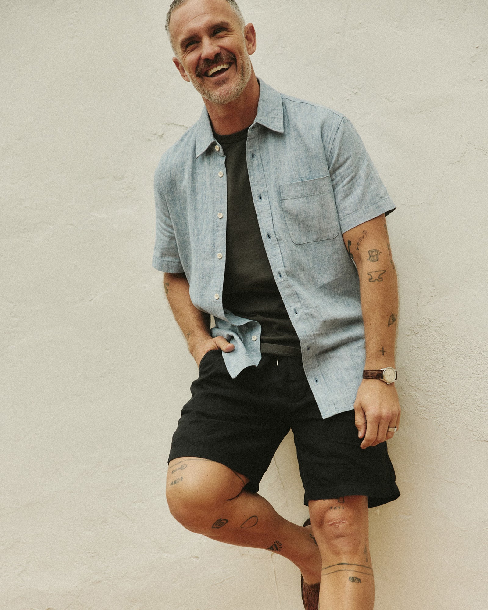 fit model leaning against the wall wearing The Apres Short in Coal Hemp, Bottoms by Taylor Stitch