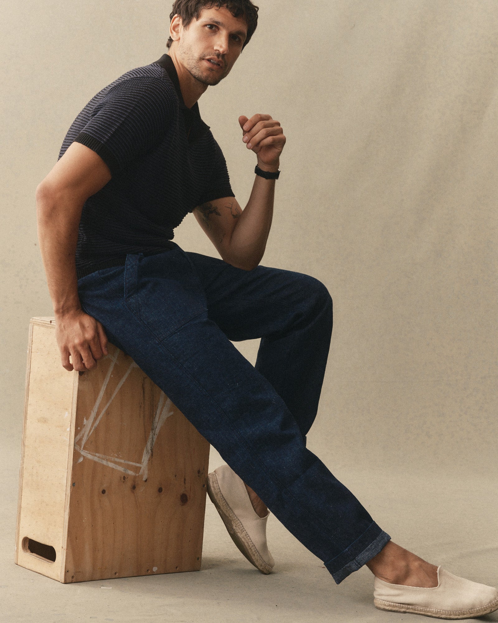 fit model sitting wearing The Breakwater Pant in Rinsed Indigo Hemp Denim, Bottoms by Taylor Stitch