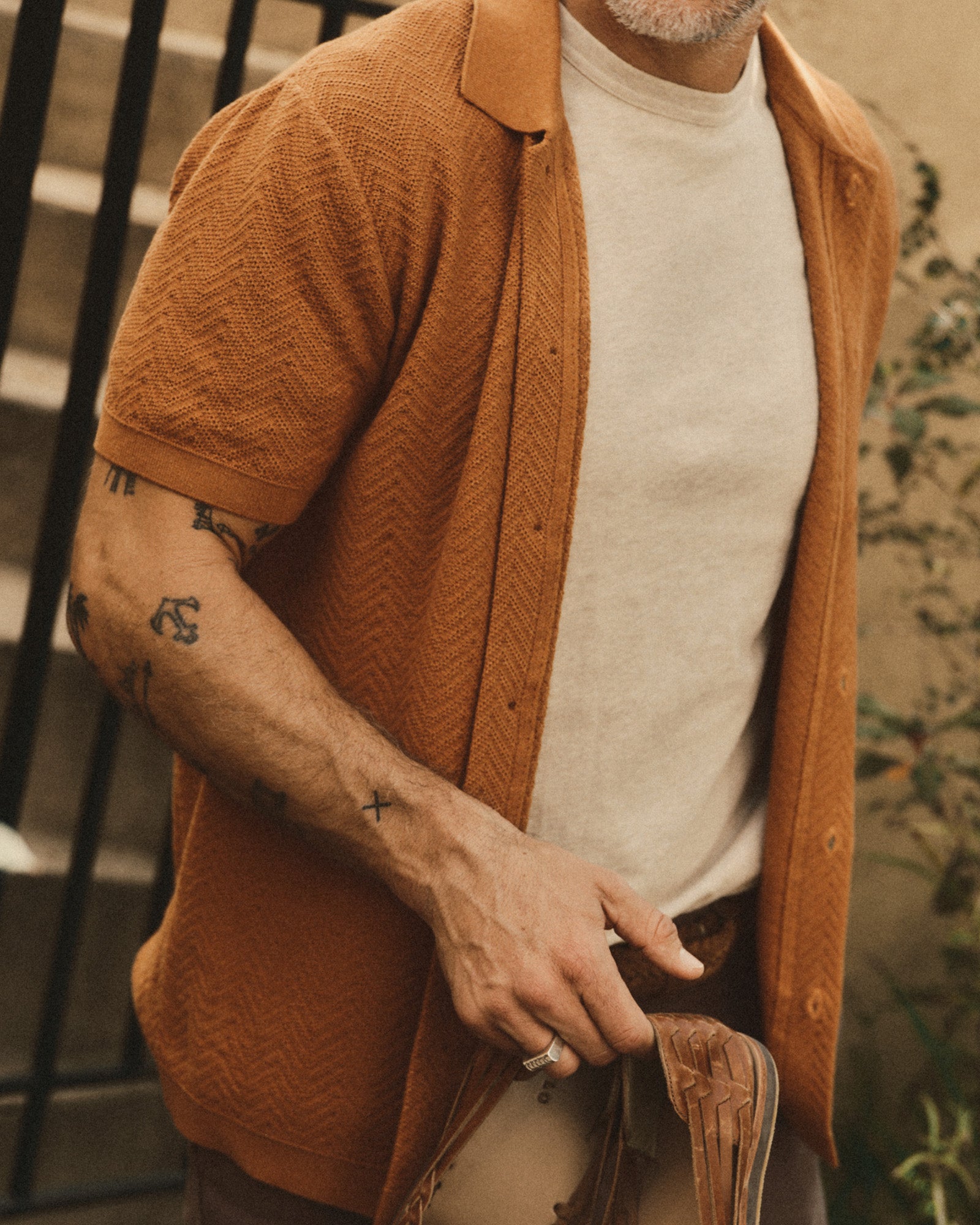 fit model showing off The Button Down Polo in Desert Herringbone, Knits by Taylor Stitch