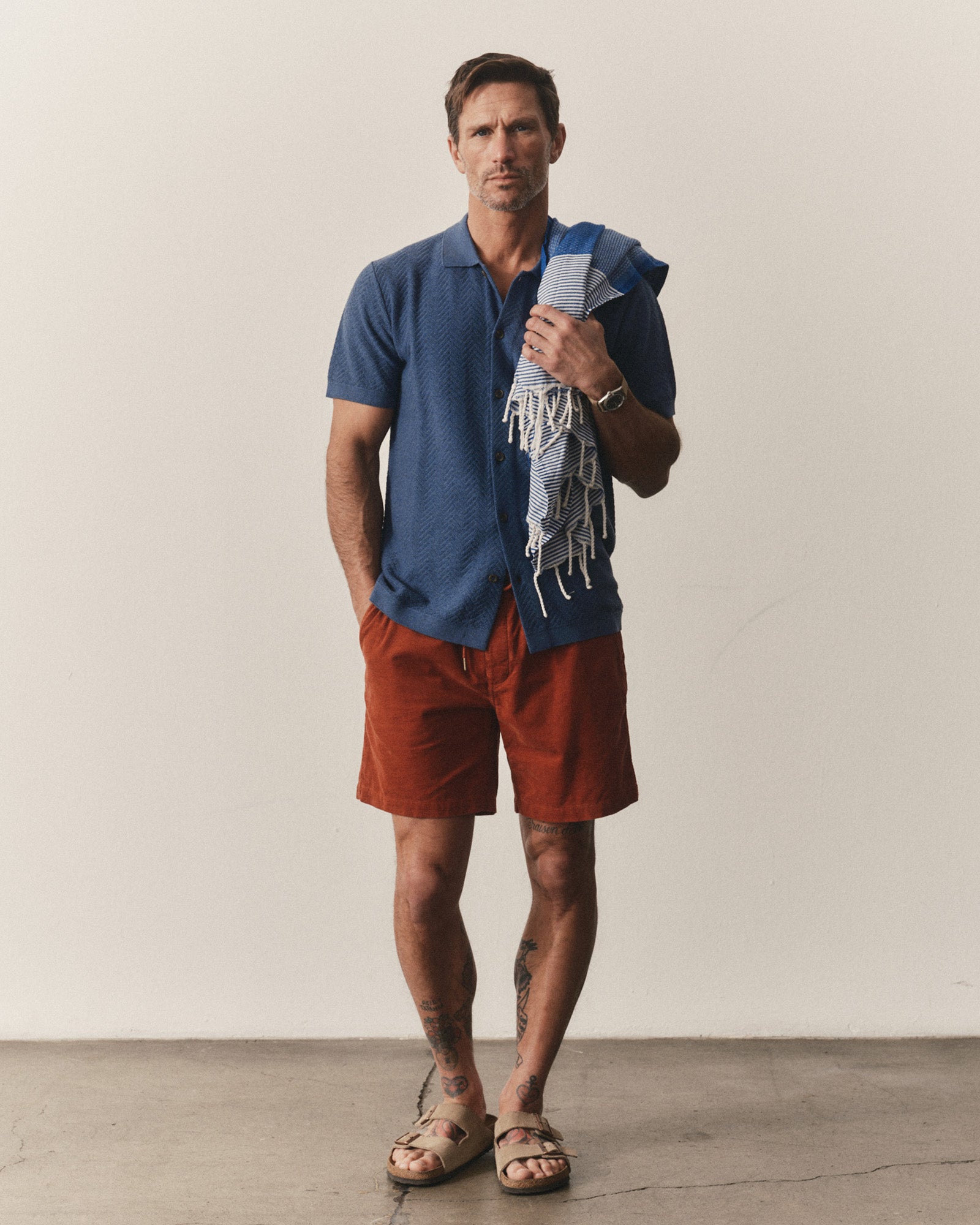 fit model posing in The Button Down Polo in Gulf Stream Herringbone, Knits by Taylor Stitch