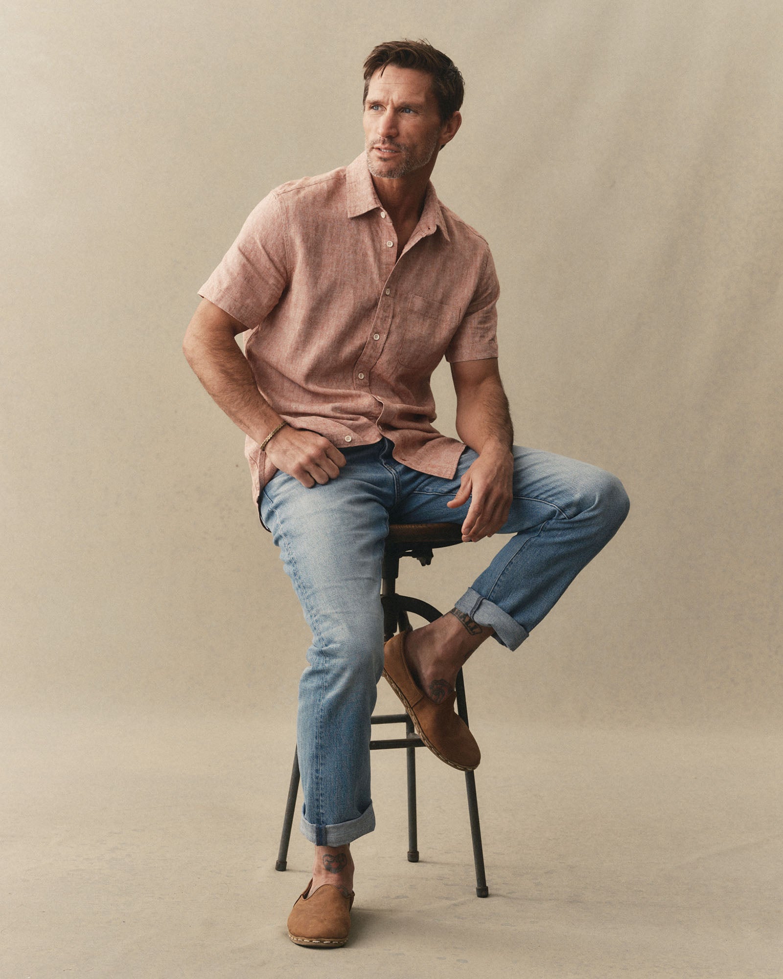 fit model sitting wearing The Democratic Jean in Light Wash Hemp Denim, Bottoms by Taylor Stitch