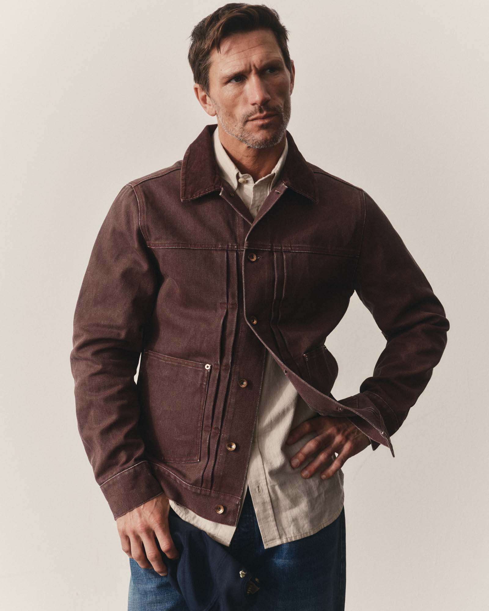 fit model posing in The Ryder Jacket in Burgundy Chipped Canvas, Outerwear by Taylor Stitch