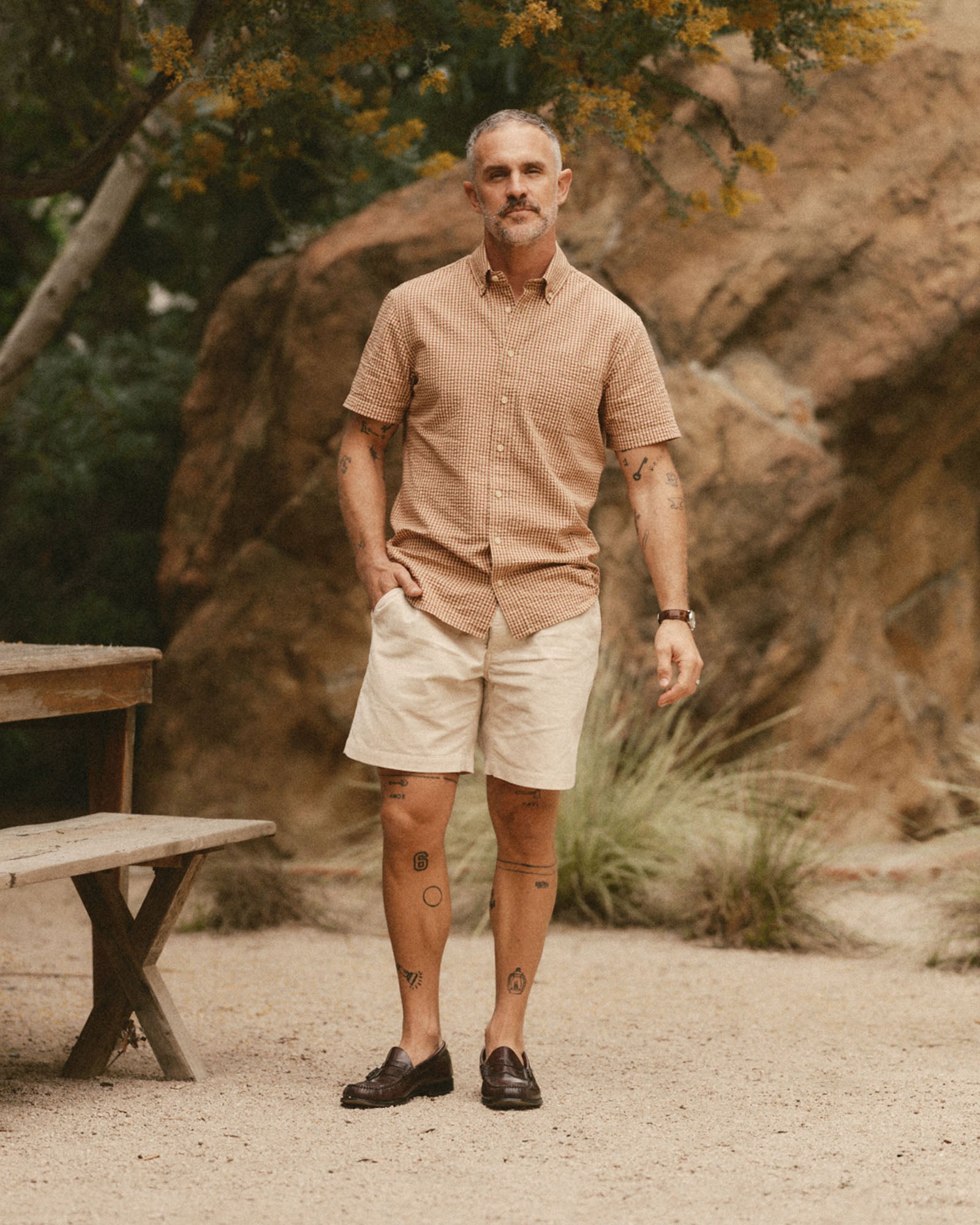 fit model posing in The Short Sleeve Jack in Brick Check Seersucker, Wovens by Taylor Stitch