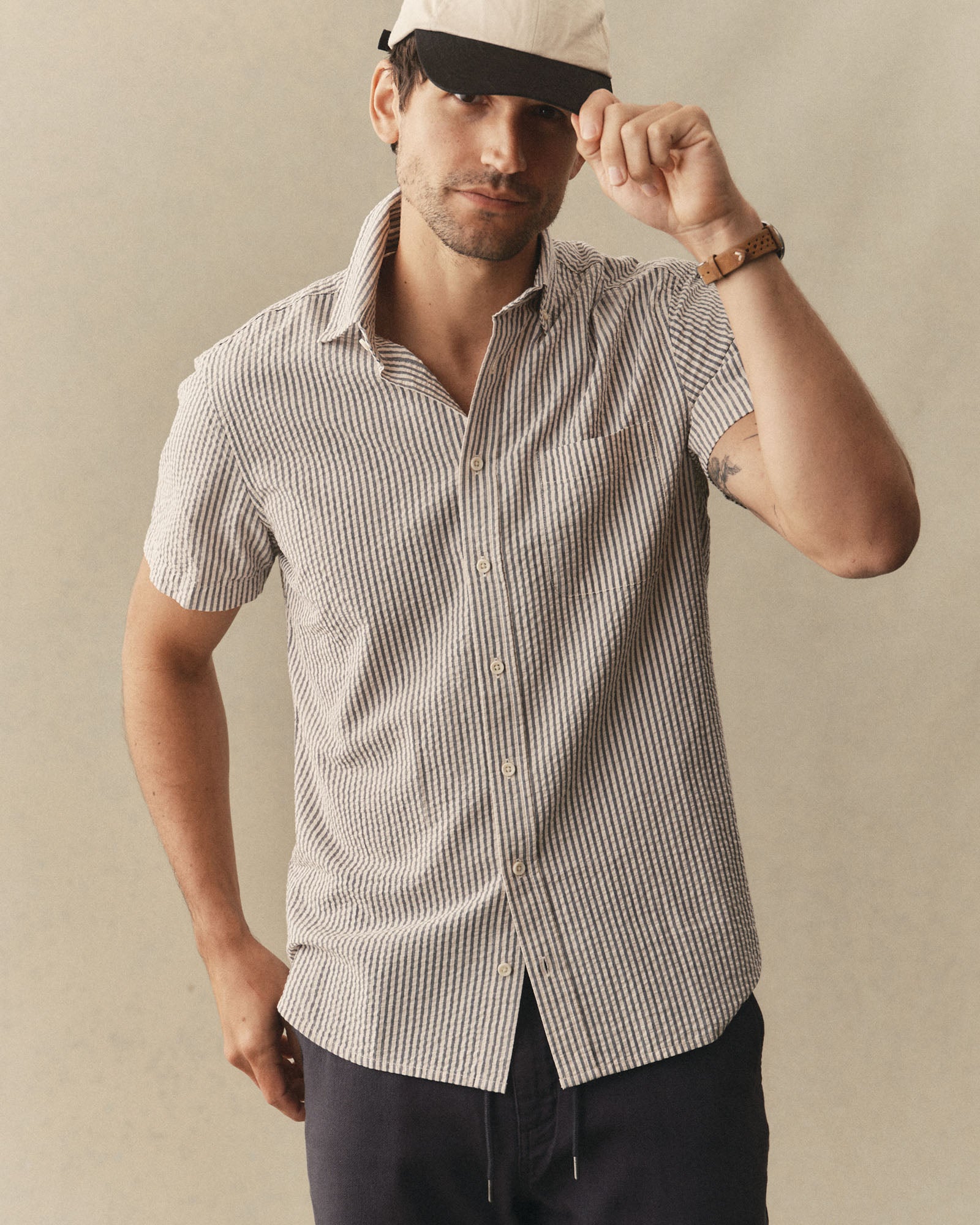 fit model posing in The Short Sleeve Jack in Steel Blue Stripe Seersucker, Wovens by Taylor Stitch