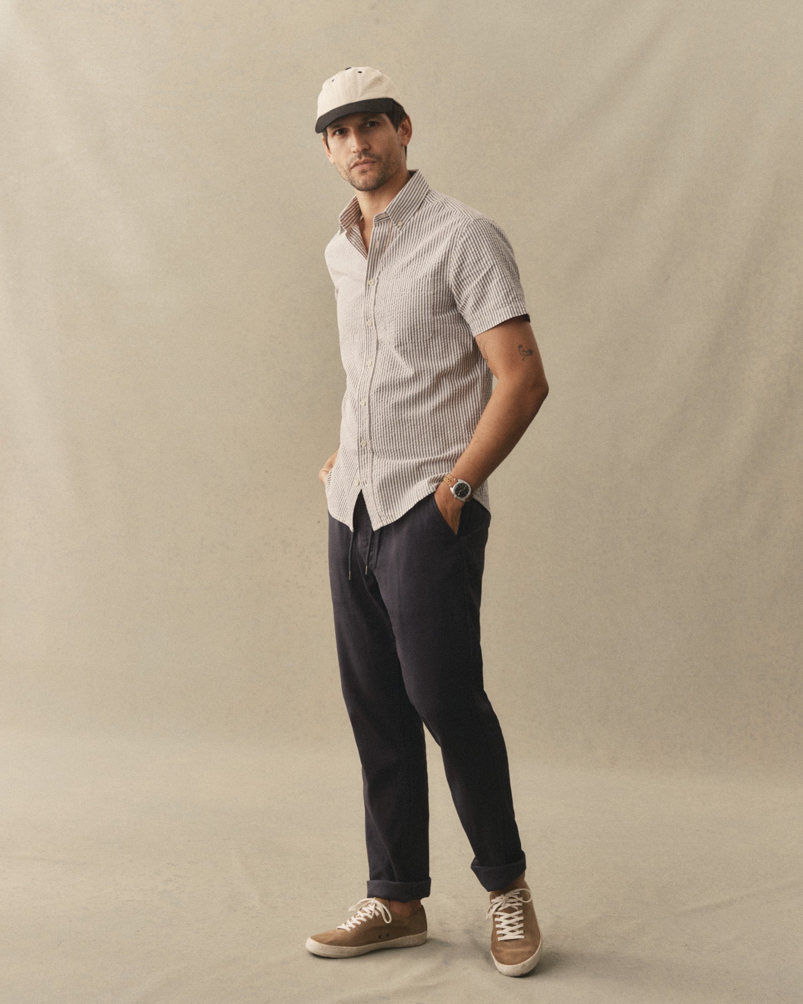 fit model posing in The Short Sleeve Jack in Steel Blue Stripe Seersucker, Wovens by Taylor Stitch