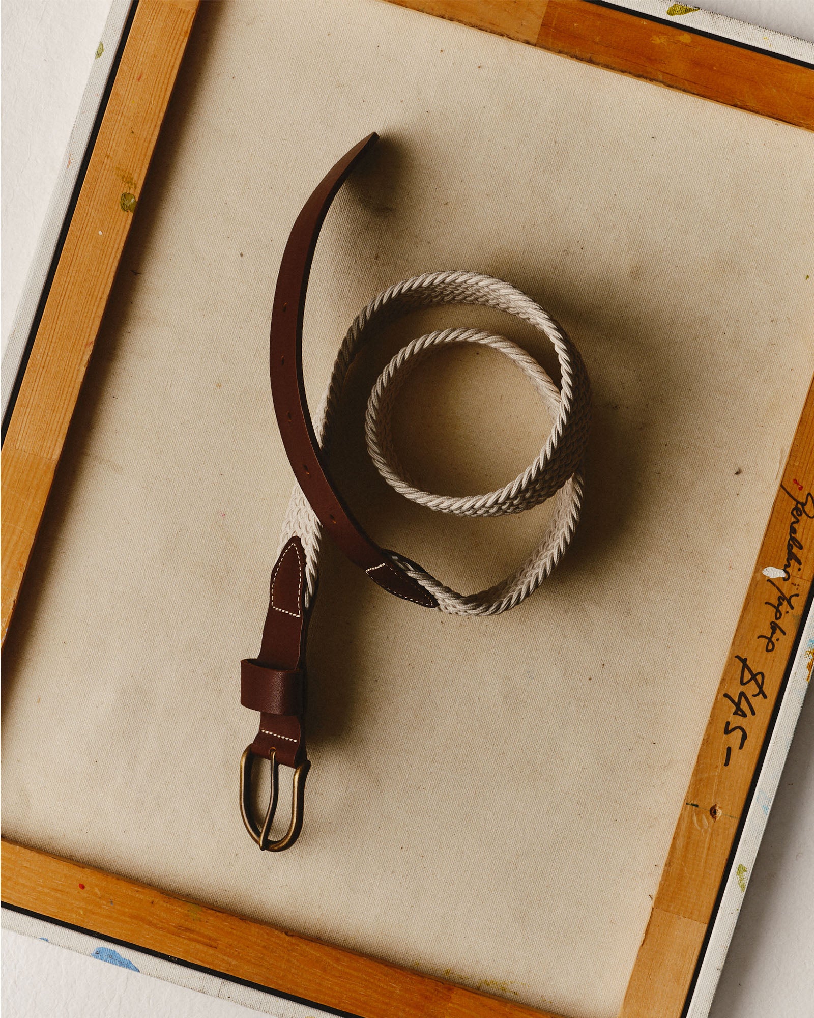 editorial flatlay of The Stretch Braided Belt in Natural on acanvas, Accessories by Taylor Stitch