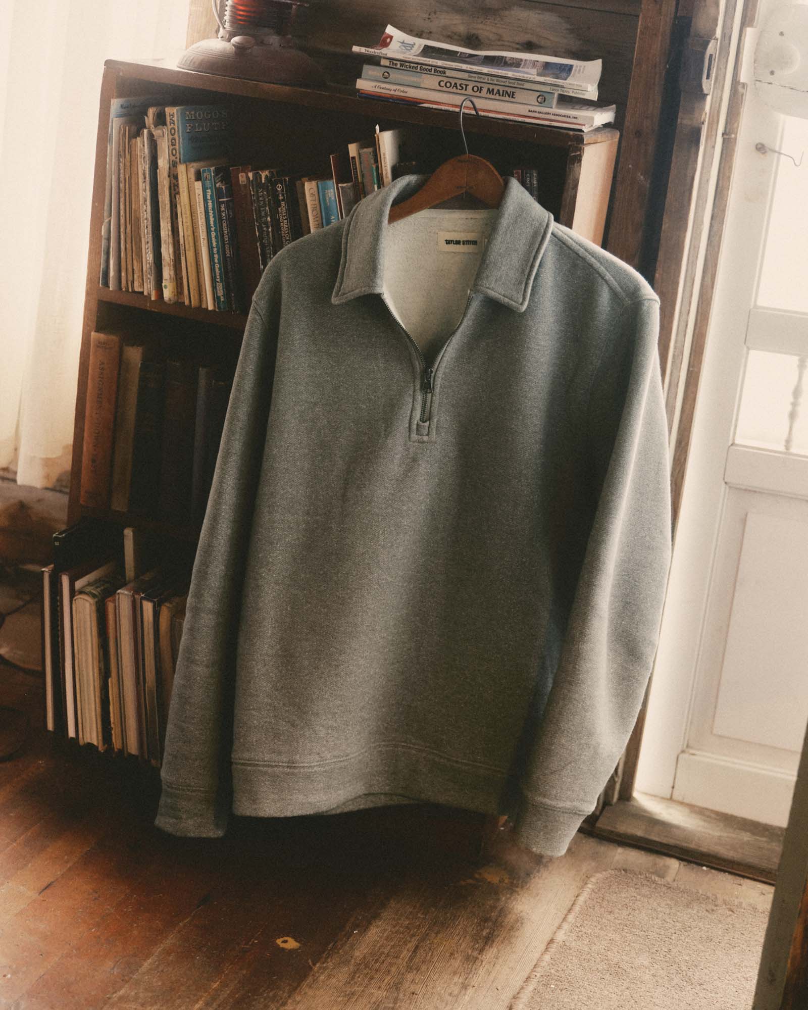 editorial image of The Armor Quarter Zip in Heather Grey Cotton Hemp hanging, Knits by Taylor Stitch